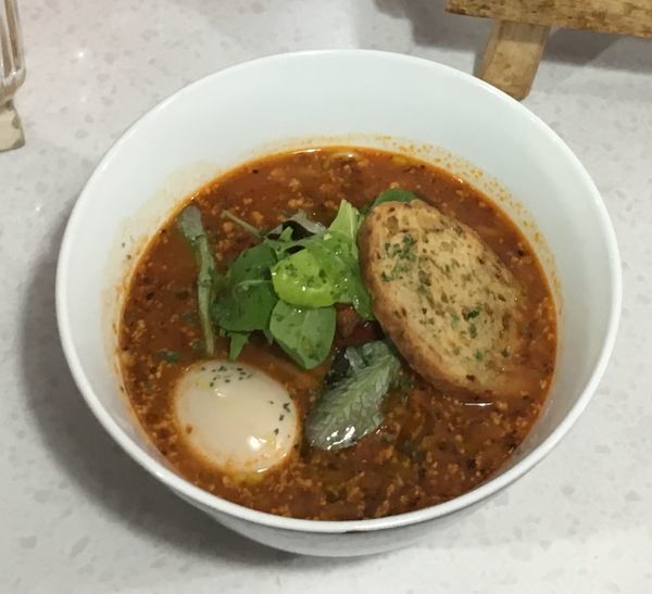 「Polpo affogatoをのせたボンゴレロッソスープの…」@ラーメン星印の写真