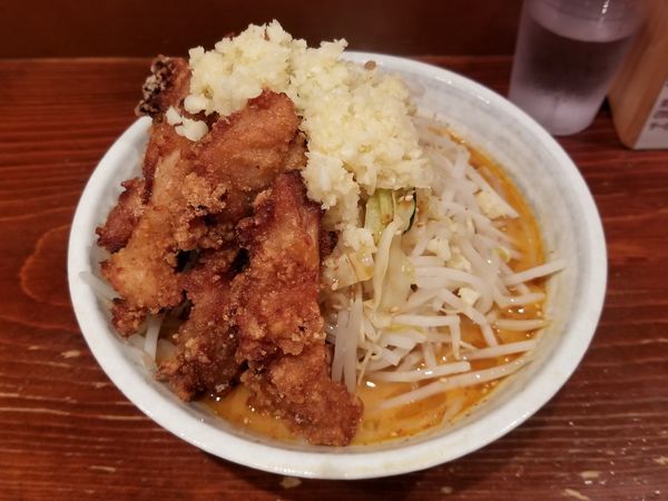 「旨辛味噌DX + 唐揚げ1本(クーポン)」@旨辛ラーメン表裏 高田馬場店の写真