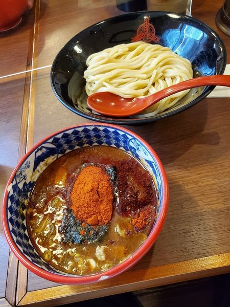 「灼熱つけ麺　極限　並」@つけ麺専門店 三田製麺所 池袋西口店の写真